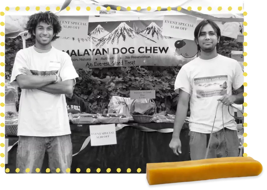 Founders of Himalayan Pet Supply standing in front of one of their first booths